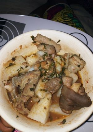 A picture of Boiled Yam with Goat meat and assorted meat peppersoup.