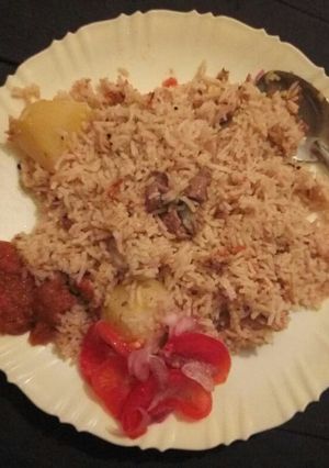 A picture of Mbuzi pilau using a jiko.