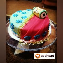 A picture of Mehndi themed cake.