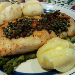 A picture of Rockling on steamed Asparagus with capers.