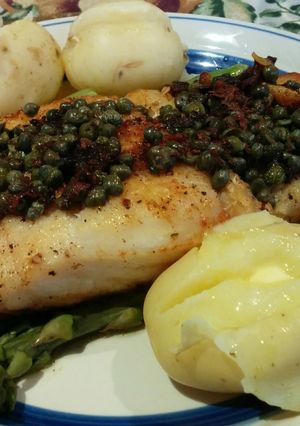 A picture of Rockling on steamed Asparagus with capers.