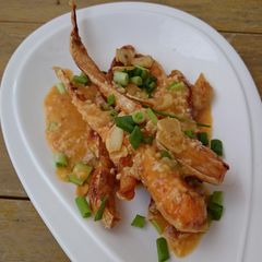A picture of Salmon In Butter Sauce Top Crispy Garlic.