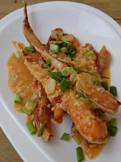 A picture of Salmon In Butter Sauce Top Crispy Garlic.
