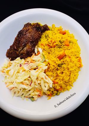 A picture of Fried rice with coselow and fried chicken.