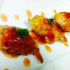 A picture of Kanya's Shrimps wrapped with Chicken and Cheese.