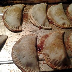 A picture of apple and chocolate empanadas.