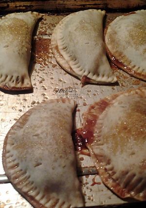 A picture of apple and chocolate empanadas.