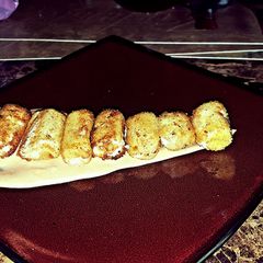 A picture of Mozzarella poppers with special sauce.