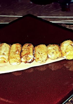 A picture of Mozzarella poppers with special sauce.