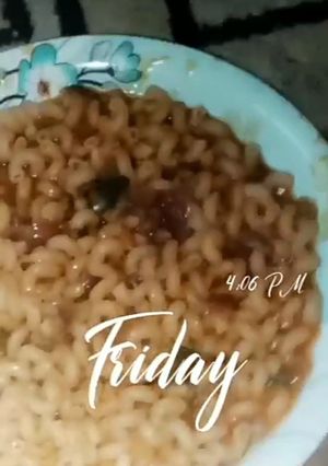 A picture of Jollof Macaroni Pasta and beans with vegetables.