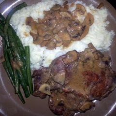 A picture of Pork Chop With sauteed mushrooms.