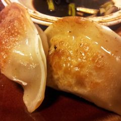 A picture of Chicken/ Shrimp Pot Stickers and Ginger Dipping Sauce.