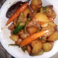 A picture of Grilled potatoes with baby vegtables.