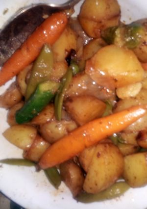 A picture of Grilled potatoes with baby vegtables.