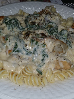A picture of Chicken & shrimp with a garlic - feta cheese florintine sauce.
