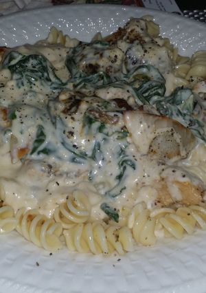 A picture of Chicken & shrimp with a garlic - feta cheese florintine sauce.