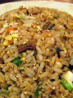 A picture of hibachi style fried rice with ginger sauce.