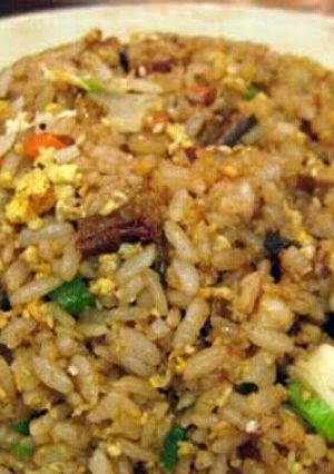 A picture of hibachi style fried rice with ginger sauce.