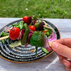 A picture of Goodness grilled padron chilli, red onions, baby tomatoes with honey mustard.