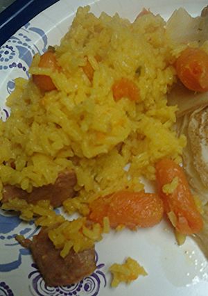 A picture of Yellow rice carrots with sausage.