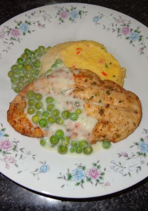 A picture of Grilled Chicken Breasts with Polenta and Pea Sauce.