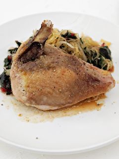 A picture of Guinea Hen with Greens and Spaghetti Squash.