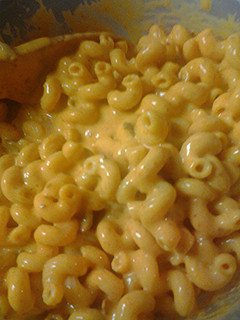 A picture of Macaroni and leftover nacho cheese.