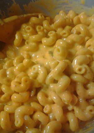 A picture of Macaroni and leftover nacho cheese.
