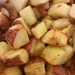 A picture of Herb roasted potatoes & garlic.
