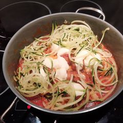 A picture of Zucchini noodles with cheesy meatballs.