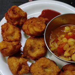 A picture of #MSR#Moog dal bajji with kabuli channa and tomato sauce.