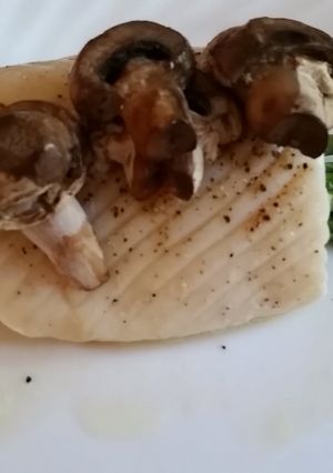 A picture of Baked Halibut with asparagus and mushrooms.
