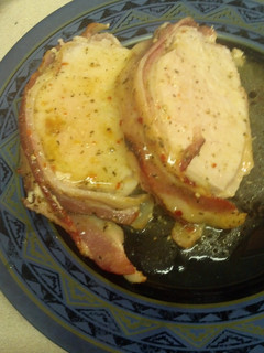 A picture of Bacon wrapped garlic and herb pork loin.