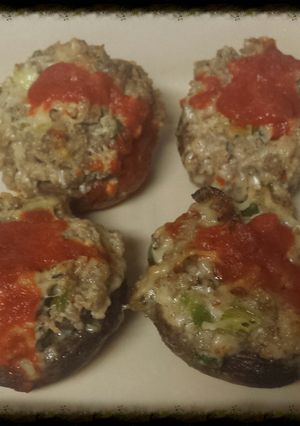 A picture of Sausage stuffed mushrooms with sriracha.