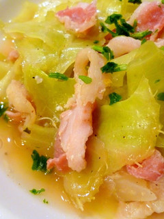 A picture of Steamed Cabbage, Onion, and Bacon in Consommé.