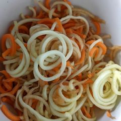 A picture of Carrot, courgette and apple salad with honey lemon dressing.