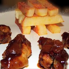 A picture of Sticky barbeque chicken wings with steak potatoes.