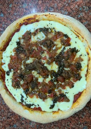 Una foto de Pizza de leudado en heladera con mozzarella, tomate y berenjena