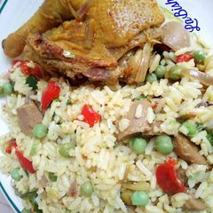 A picture of Coconut rice with fried chicken.
