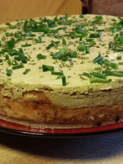 A picture of Smoked Salmon and Blue Cheese Cheesecake with an Avocado Cream Topping.