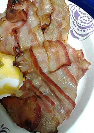 A picture of Bacon wrapped cube steak with hp sauce.