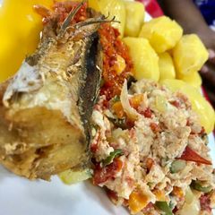 A picture of Potatoes with eggs and fish.