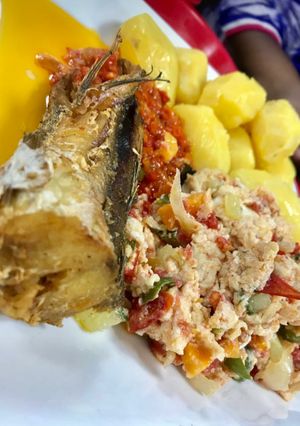 A picture of Potatoes with eggs and fish.
