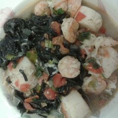 A picture of Squid ink pasta with shrimp and scallops..