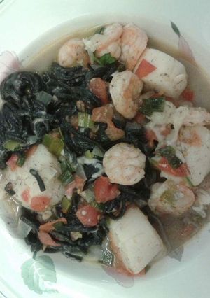 A picture of Squid ink pasta with shrimp and scallops..