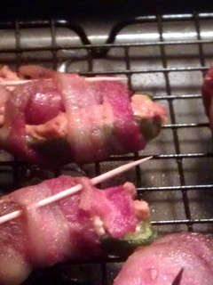 A picture of jalapeno poppers stuffed with lil' smokies.