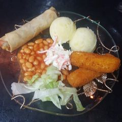 A picture of Mashed potatoes with beans& coleslaw.