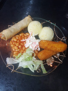 A picture of Mashed potatoes with beans& coleslaw.