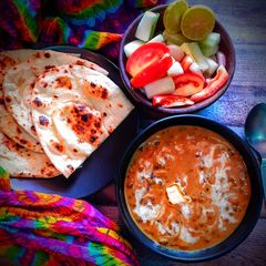 A picture of Dal Makhani with butter naan.