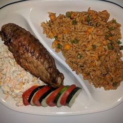 A picture of Jollof rice,fried turkey and coleslaw.